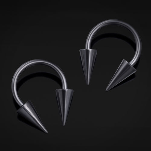Pair of metallic hoop earrings with spike details on a black background